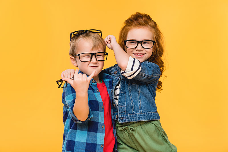 kids trying on eyeglasses